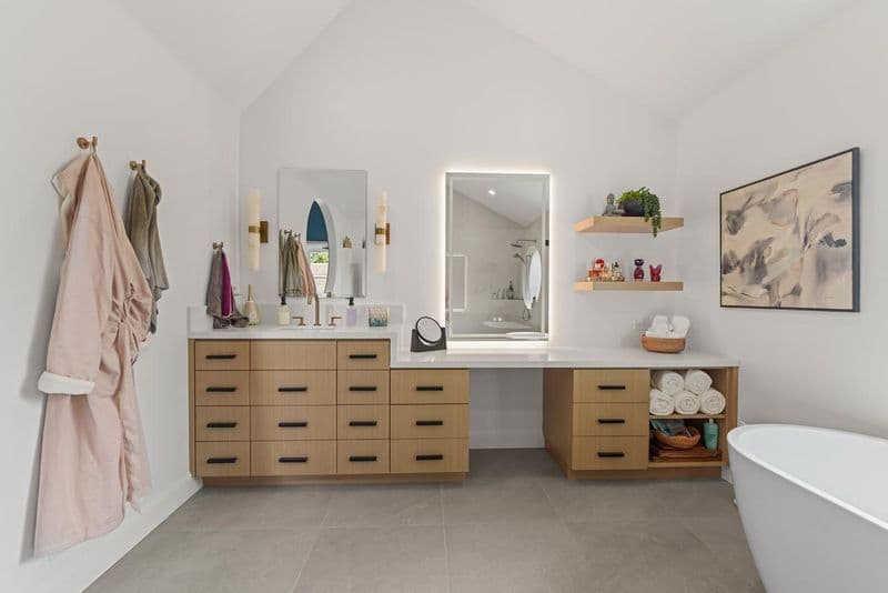 primary bathroom after: floating wood vanity with makeup counter with white oak cabinetry and quartz countertop, by ASL Remodeling, Pacifica.
