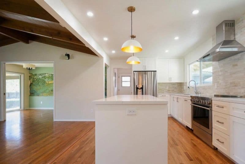 kitchen after: white shaker cabinets with quartz island with quartz countertop and white shaker cabinetry, by ASL Remodeling, Los Gatos.