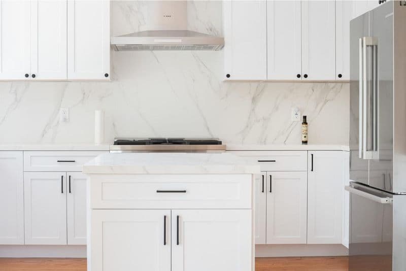 kitchen: white shaker cabinets with marble slab backsplash with marble or quartz slab backsplash and white shaker cabinetry, by ASL Remodeling, San Mateo.