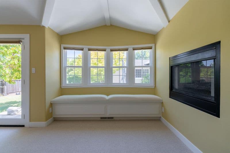 Master suite sitting area in Los Gatos with built-in wall-mounted entertainment center, custom millwork, and upgraded interior finishes