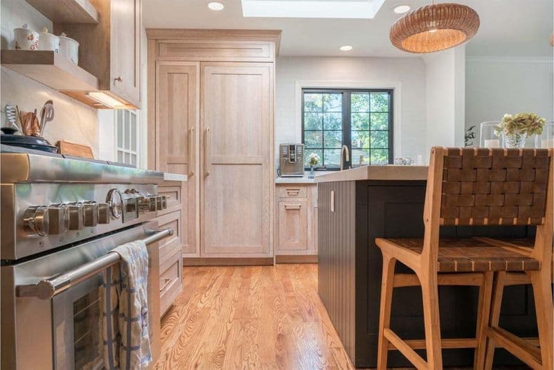 Open concept kitchen remodel in San Jose with floating shelves, seamless backsplash, custom maple cabinetry, and contemporary design with hardwood flooring