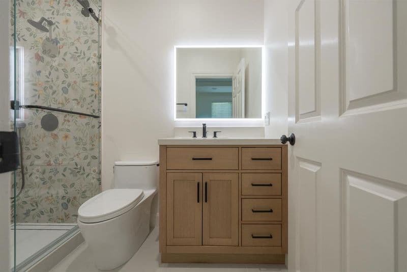 bathroom remodel with wood vanity and mirror in Los Gatos Boyer Ln by ASL Remodeling