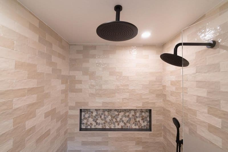 primary bathroom: dual rain head shower with pebble niche with cream stacked tile and pebble mosaic tile, by ASL Remodeling, Monte Sereno.