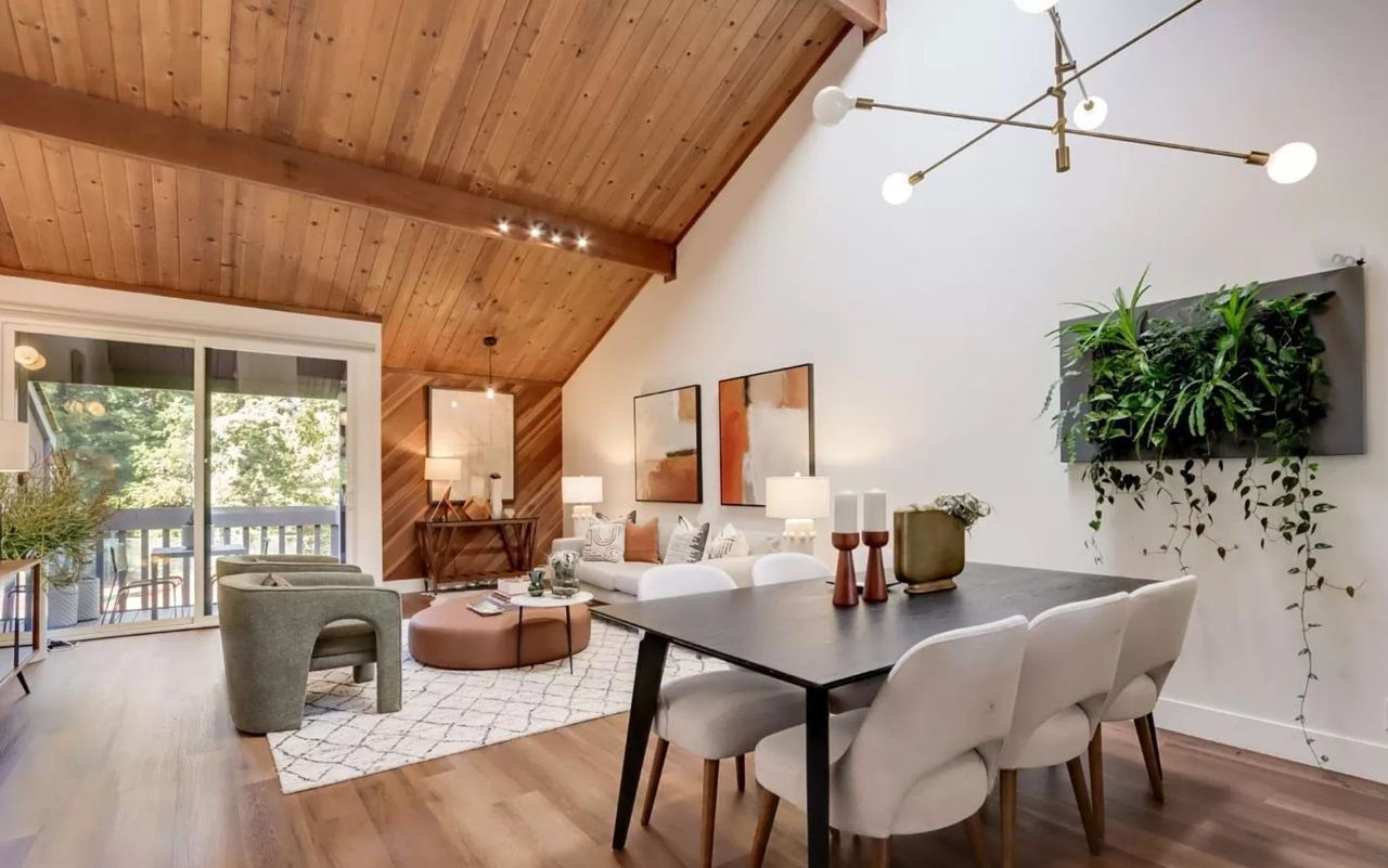 Home addition contractors create open concept living and dining space with stunning wood ceiling design