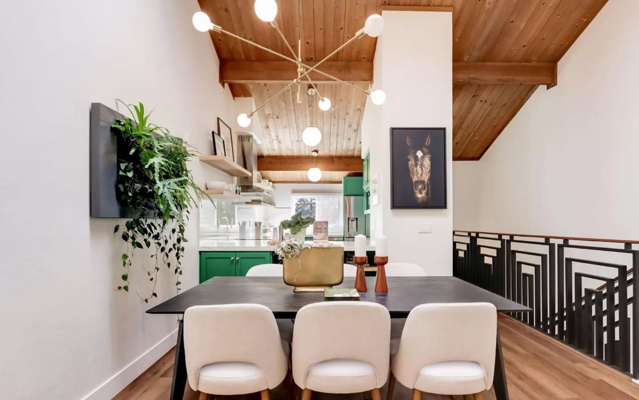 Room additions project showcasing open concept layout redesign with transitional dining space featuring wood accent ceiling, globe chandelier, and modern farmhouse styling.