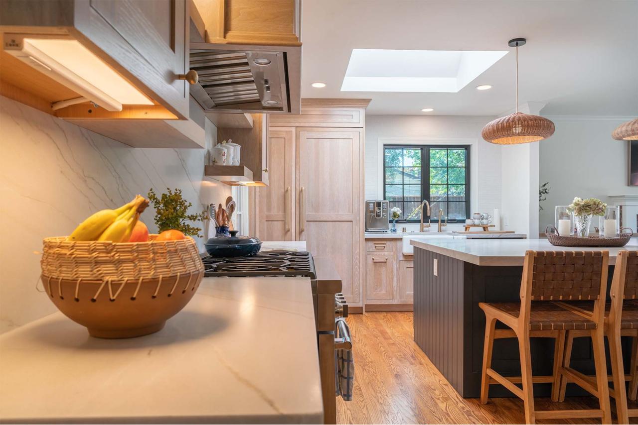 White oak cabinetry and recessed lighting create bright Los Gatos kitchen with skylight and custom island