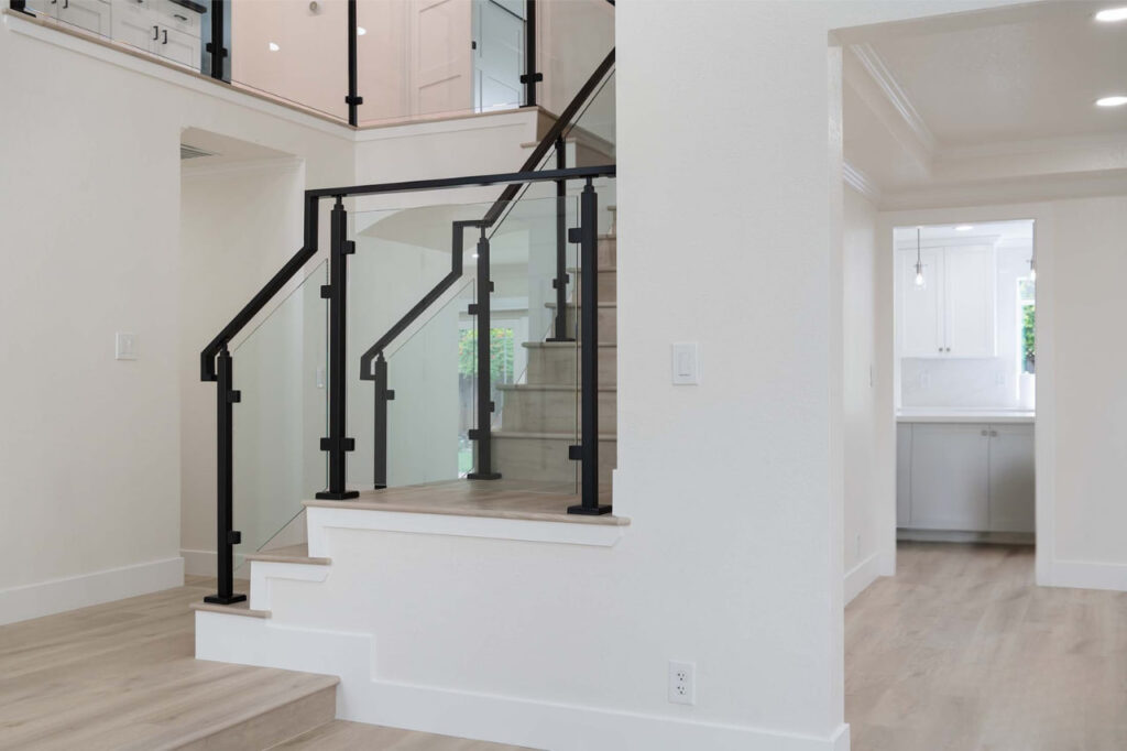 Elegant home remodeling San Jose entryway showcasing architectural planning with glass door and floating staircase design