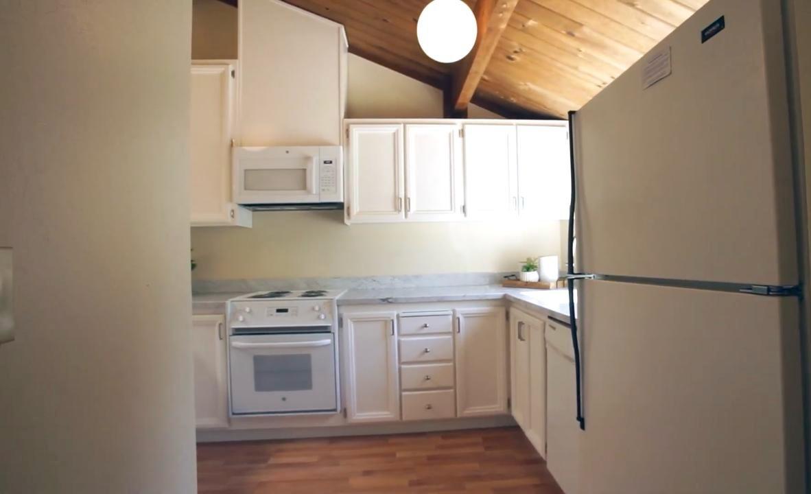 Before kitchen on Central Ave in Mountain View with white cabinetry and wood ceiling prior to custom green maple cabinet installation