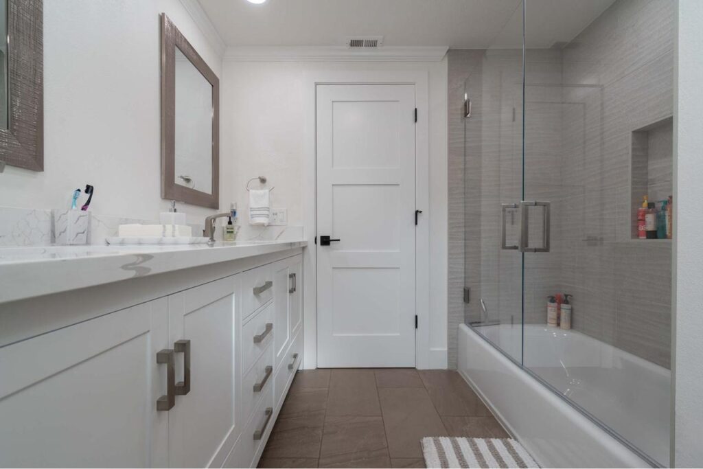 San Jose bathroom on Crossmont Circle with vanity, frameless glass enclosure, recessed niches, and spa-inspired tilework