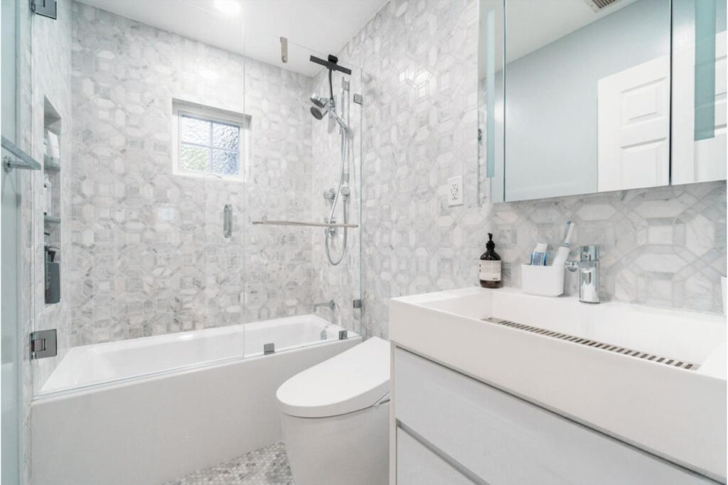 Professional bathroom remodeling services in Los Gatos featuring marble hexagon tile and floating white vanity with modern fixtures