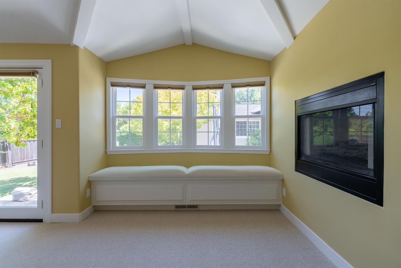 Master suite sitting area in Los Gatos with built-in wall-mounted entertainment center, custom millwork, and upgraded interior finishes