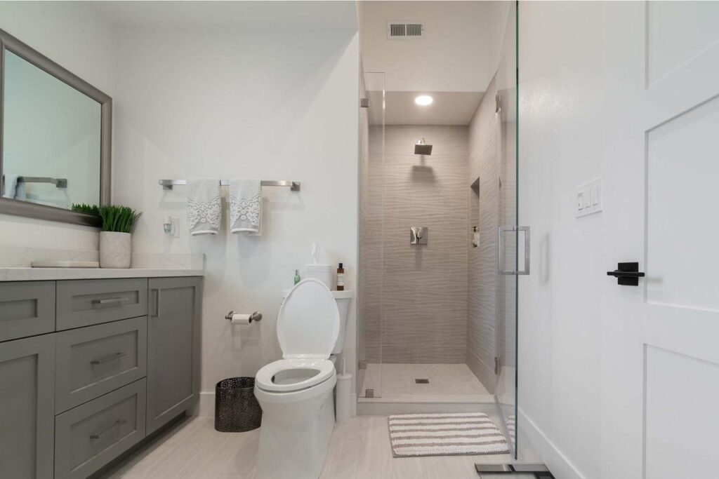 San Jose bathroom remodel on Crossmont Circle with floating vanity, frameless glass shower, textured tilework, and modern fixtures
