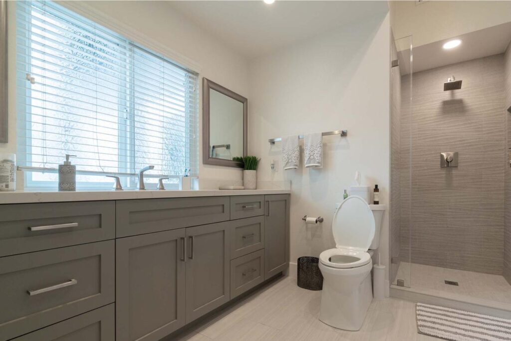 Crossmont Circle bathroom in San Jose featuring floating vanity with natural light, frameless glass shower, and carefully curated tilework