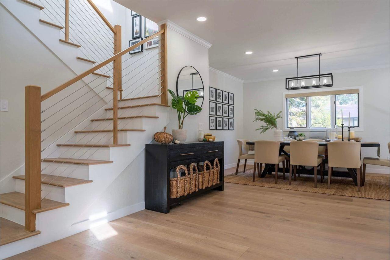 Vista Del Mar home remodel showcasing completed modern staircase with white oak treads and cable railing creating open flow in Los Gatos by ASL Remodeling