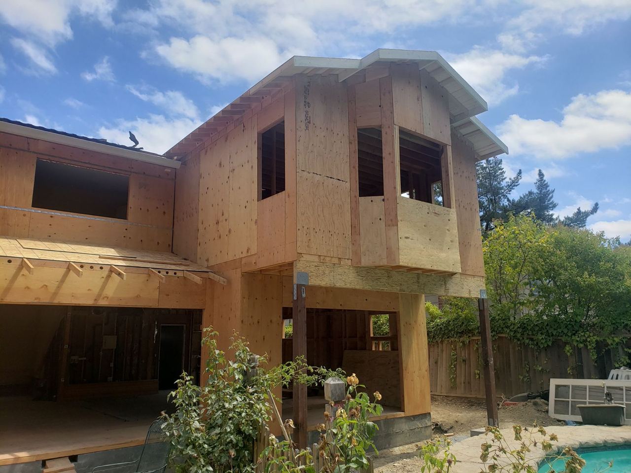 Exterior view of room addition in progress with wooden framing in San Jose.