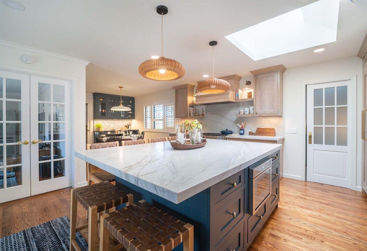 Kitchen design services featuring contemporary style with blue center island, white cabinets, and hardwood flooring