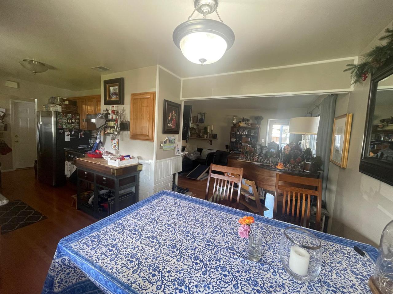 Before photo of dated kitchen and dining area in Santa Clara home renovation showing original layout with outdated light oak cabinets and decor prior to kitchen expansion and complete remodel by ASL Remodeling