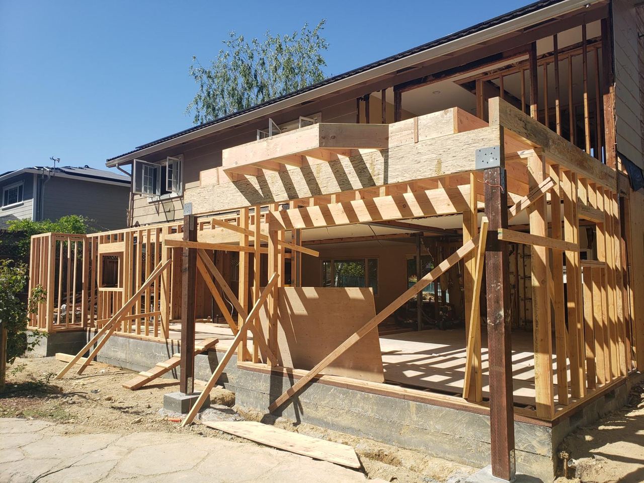 Exterior view of room addition in progress with wooden framing in San Jose.