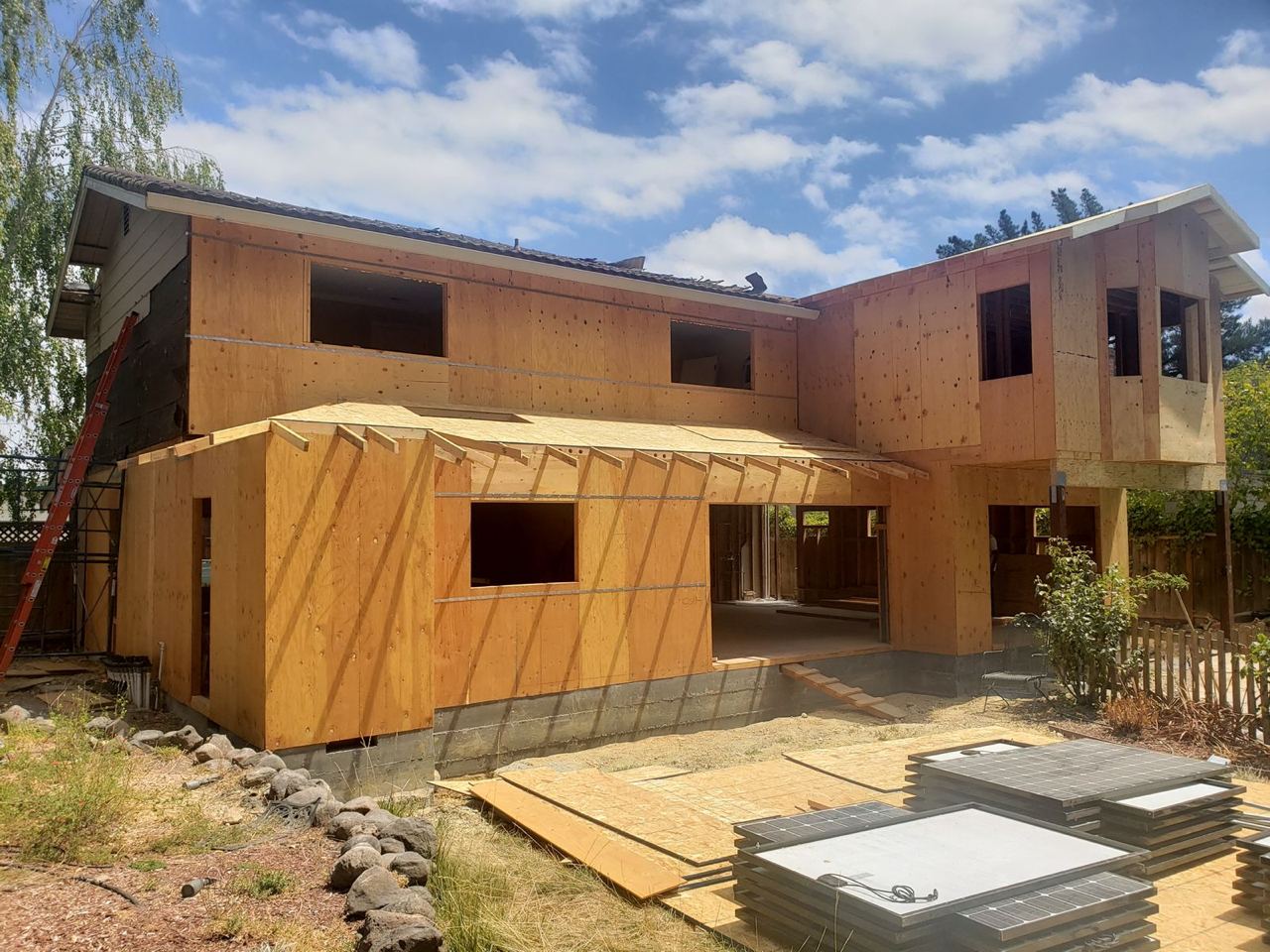 Exterior view of room addition in progress with wooden framing in San Jose.